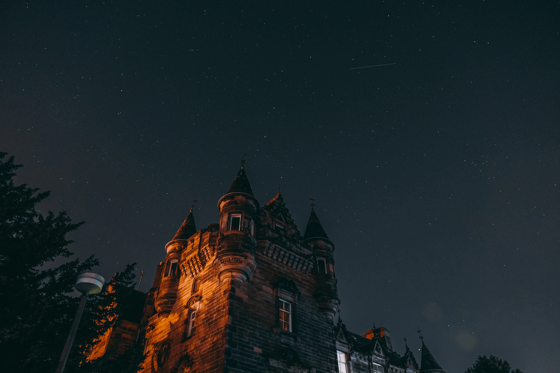 a castle at night with stars in the sky