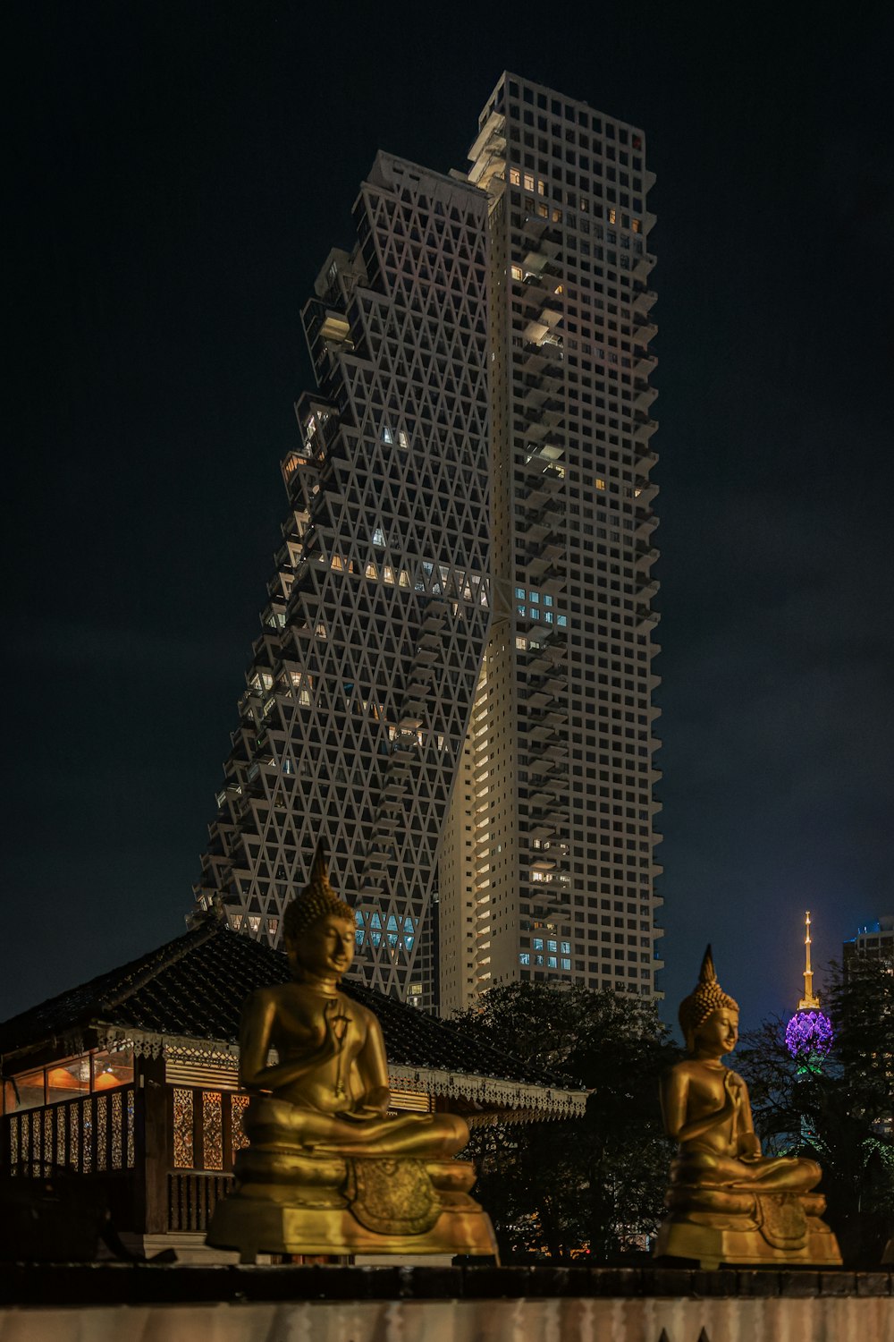 a very tall building with some statues in front of it
