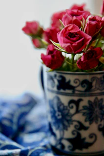 Close-up of a vibrant coffee mug featuring a custom floral design with a heartfelt message