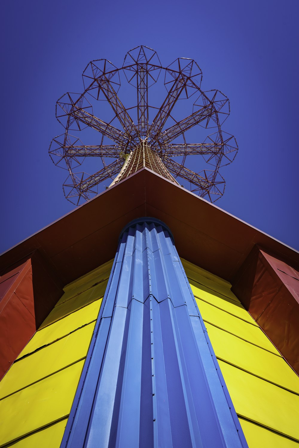 a tall tower with a ferris wheel on top of it