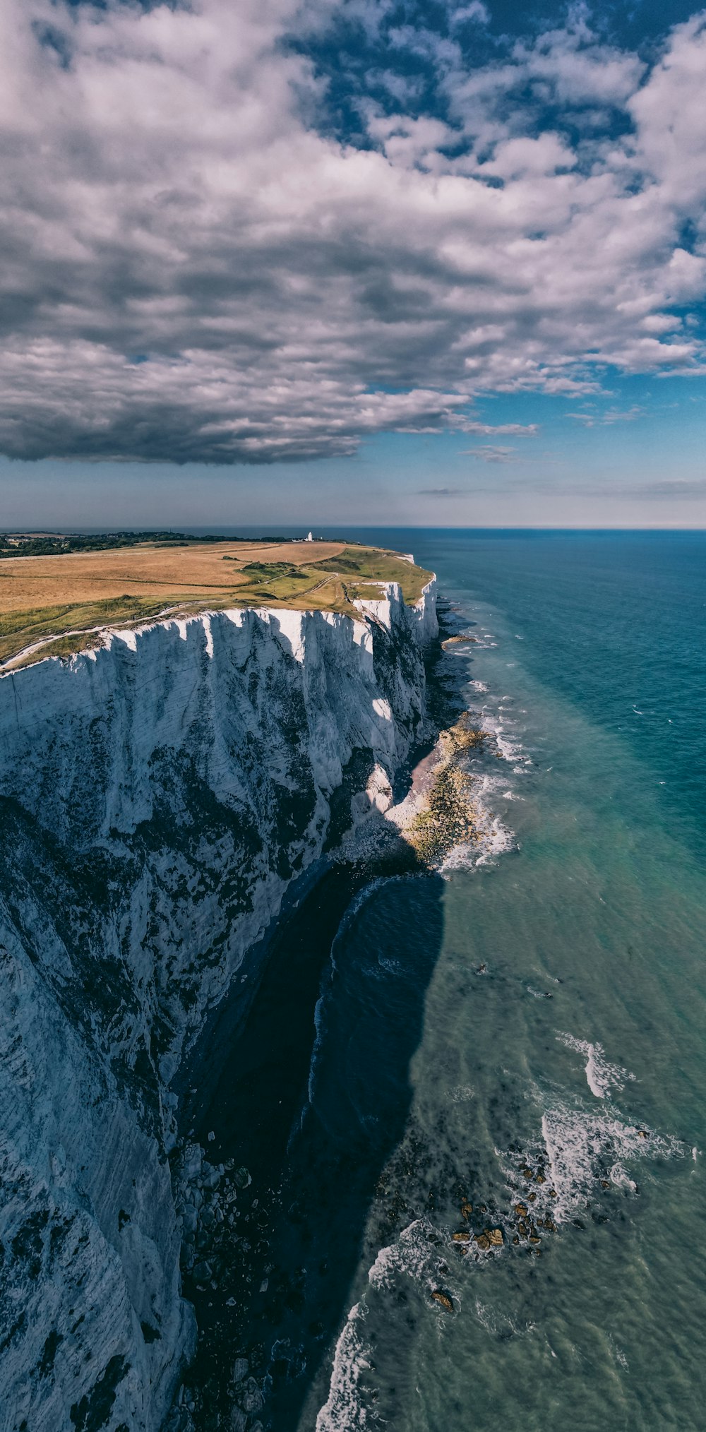 a view of the cliffs and the ocean from a helicopter