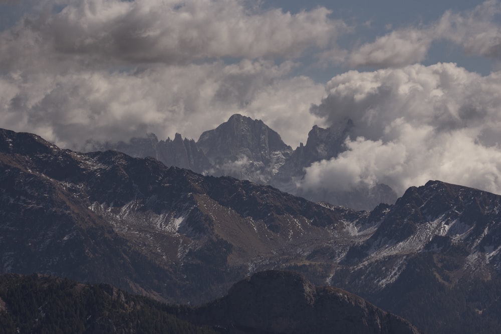 a view of a mountain range with clouds in the sky