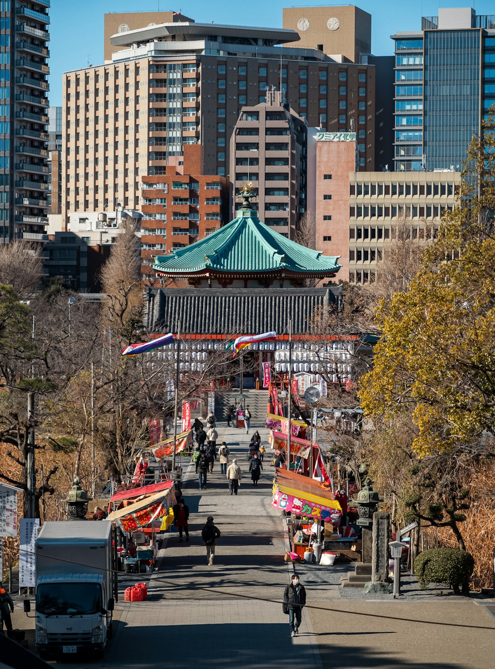 a city street with a tall building in the background