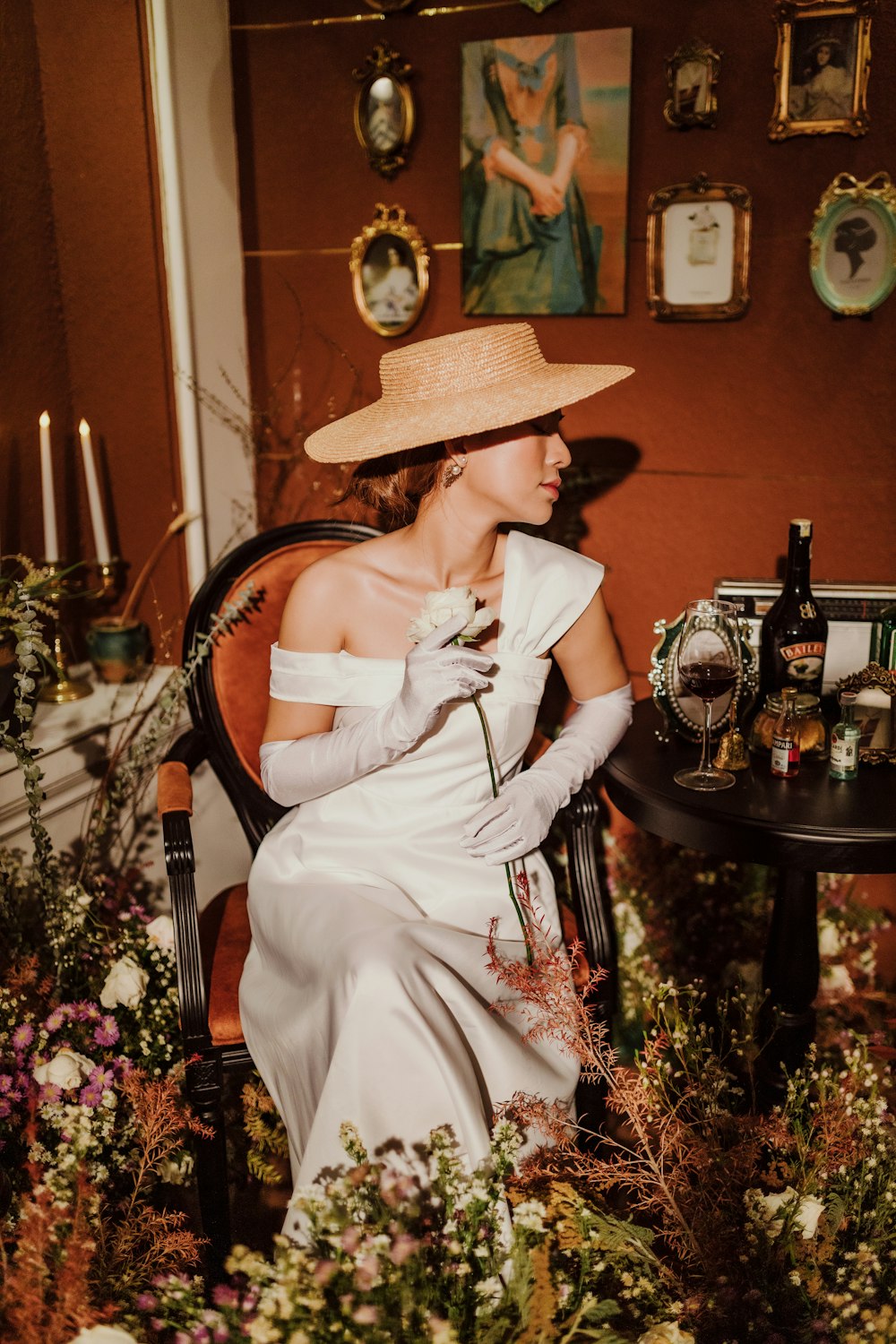 a woman sitting in a chair with a hat on