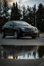 a black sports car parked in a parking lot