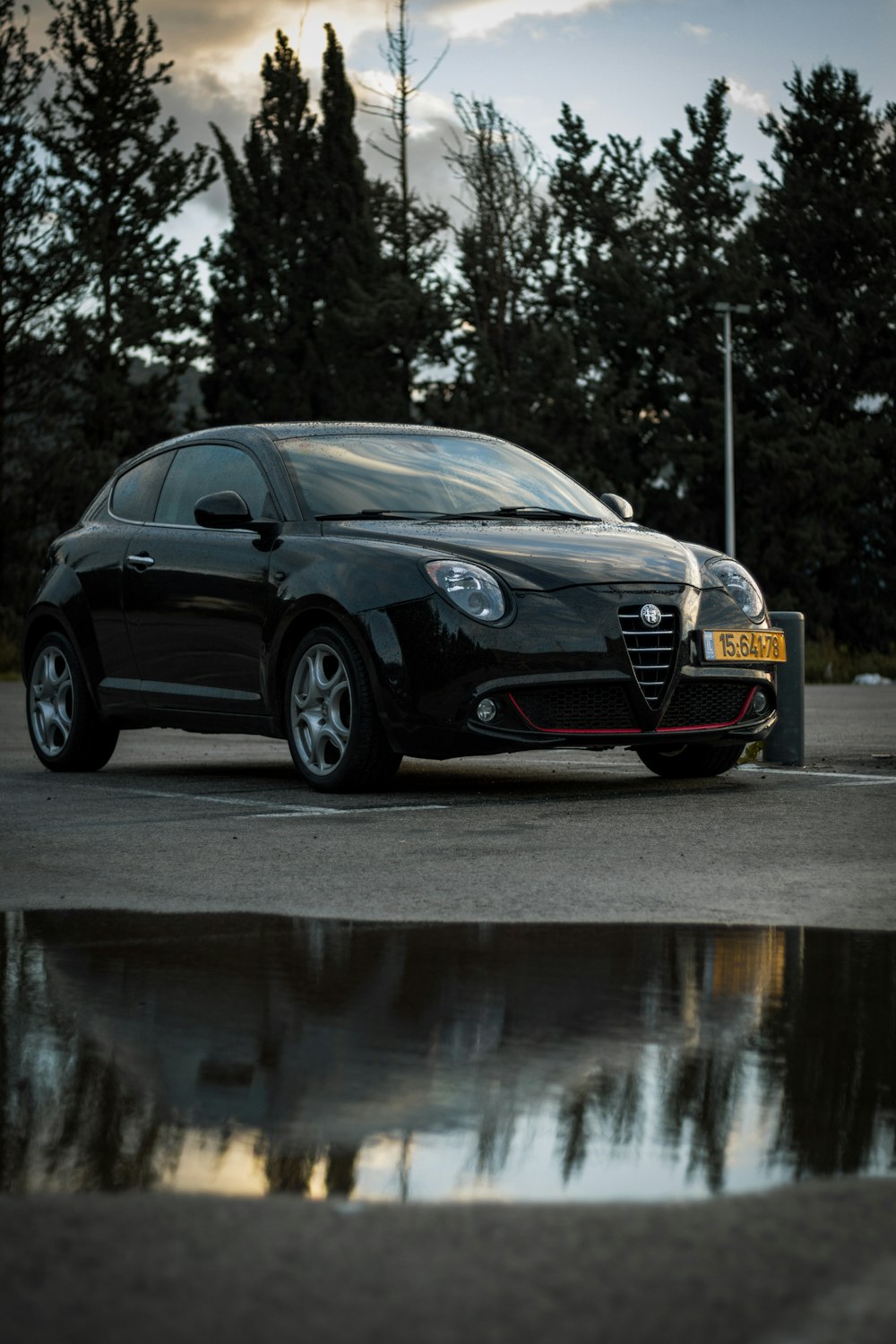 a black sports car parked in a parking lot