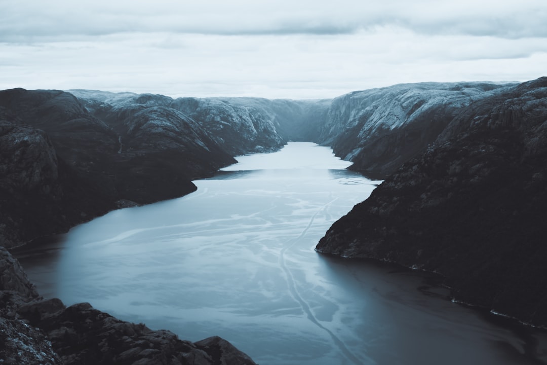 a large body of water surrounded by mountains,