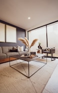 a living room filled with furniture and a large window
