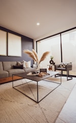 a living room filled with furniture and a large window