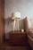 Cozy bedroom corner showcasing a custom wooden wardrobe and matching side table.