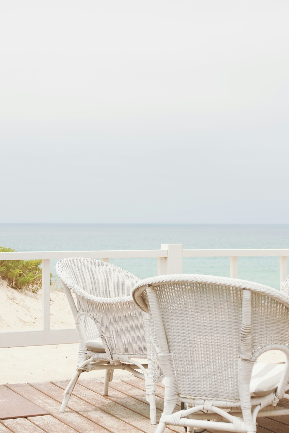 a couple of white chairs sitting on top of a wooden floor