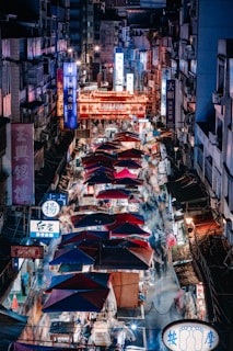 a city street filled with lots of umbrellas