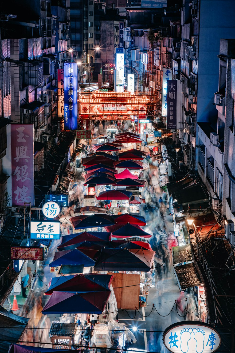 a city street filled with lots of umbrellas