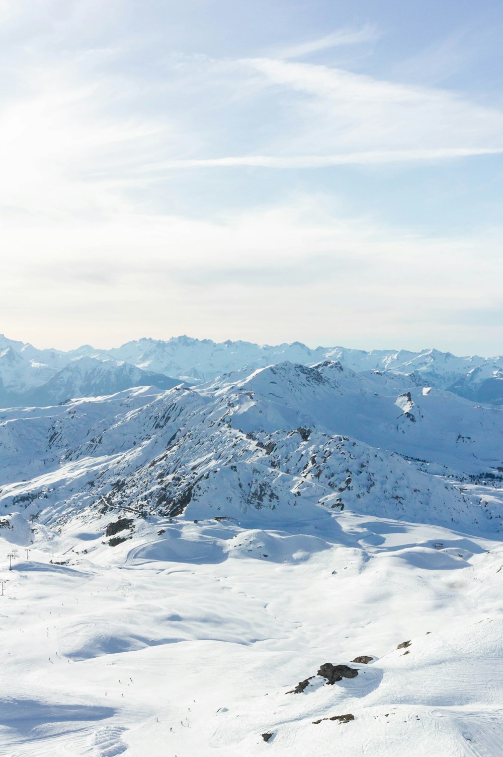 a man riding skis on top of a snow covered slope