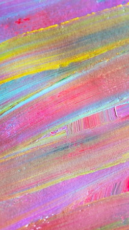 Colorful abstract painting with broad, sweeping brushstrokes in varying shades of pink, yellow, blue, and green. The texture is visible, adding depth and dimension.
