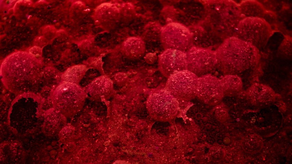 a close up of a red substance on a surface