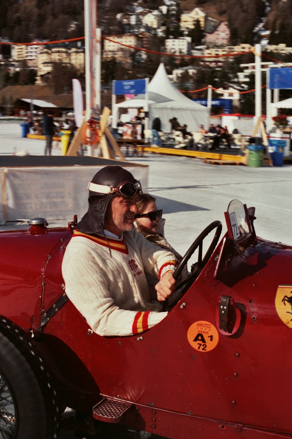 a man sitting in a red race car