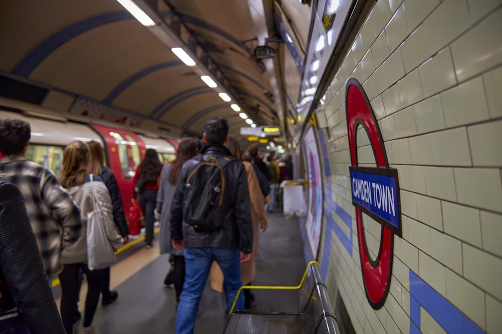 a group of people walking on a subway platform