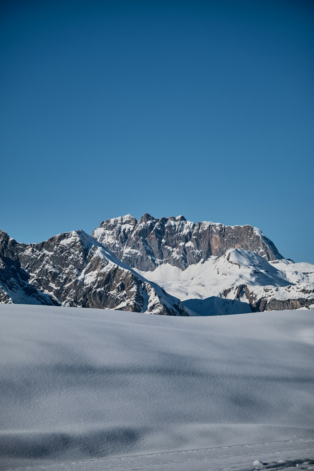 a person riding skis on top of a snow covered slope