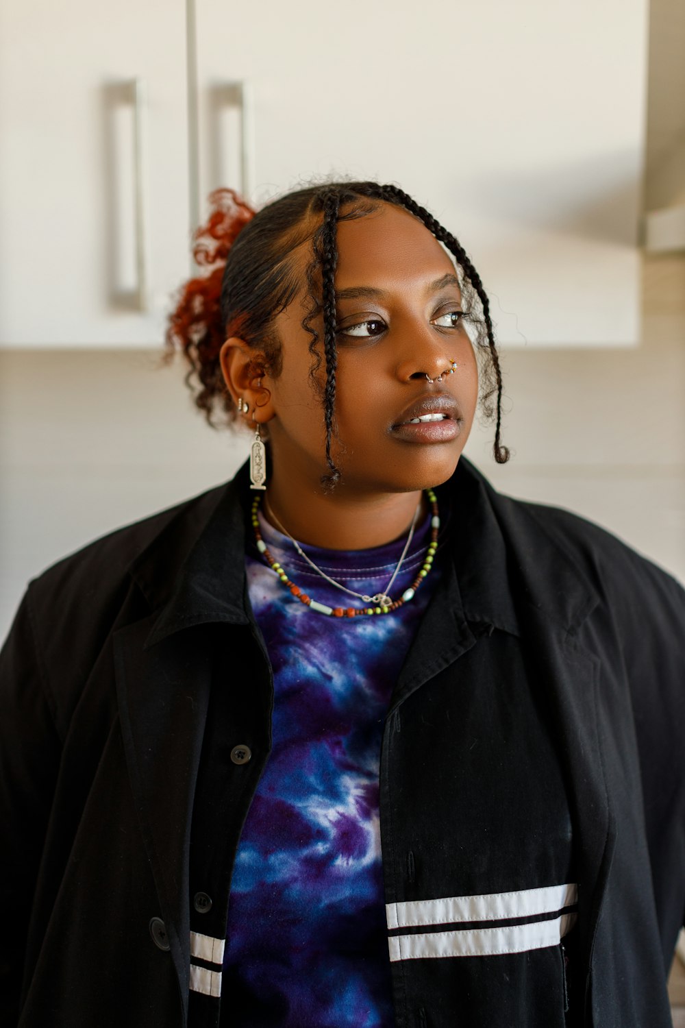 a woman with dreadlocks standing in a kitchen