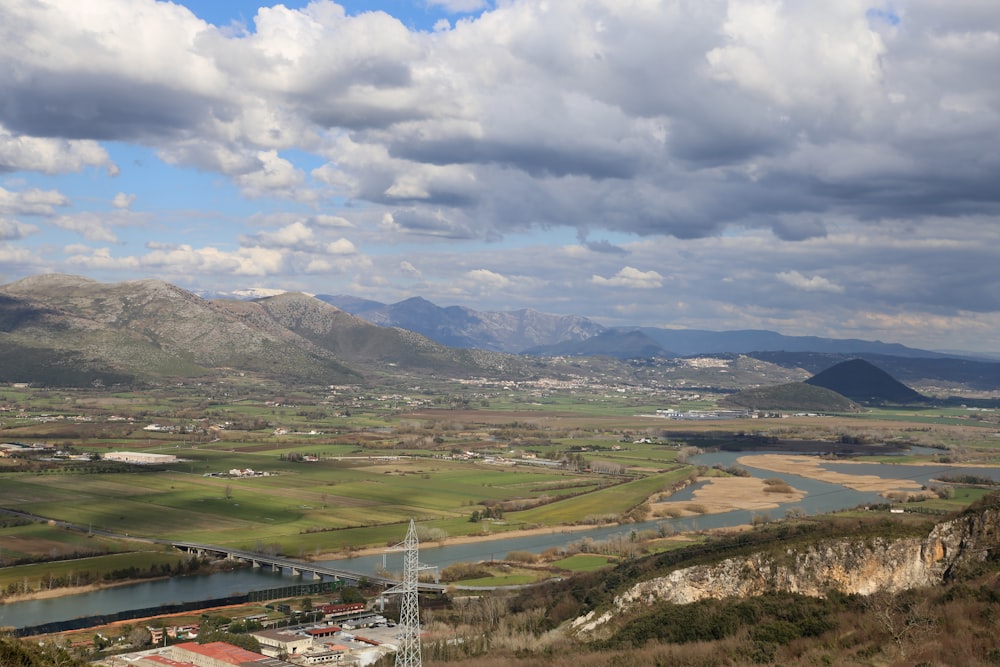 a scenic view of a valley and a bridge