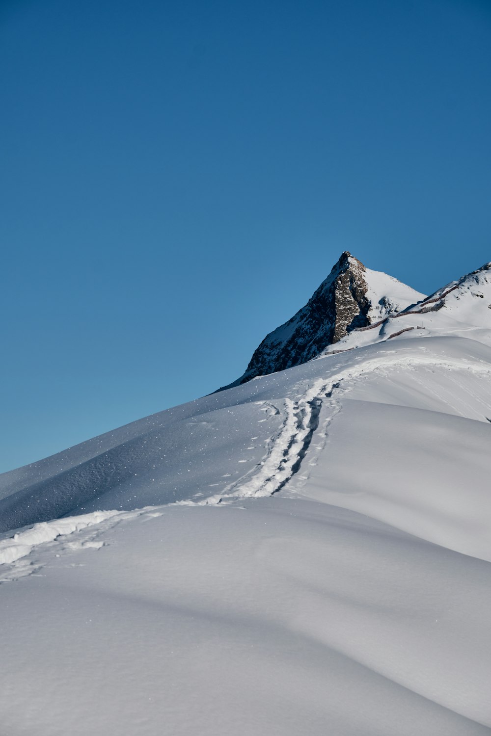 a man riding skis down a snow covered slope