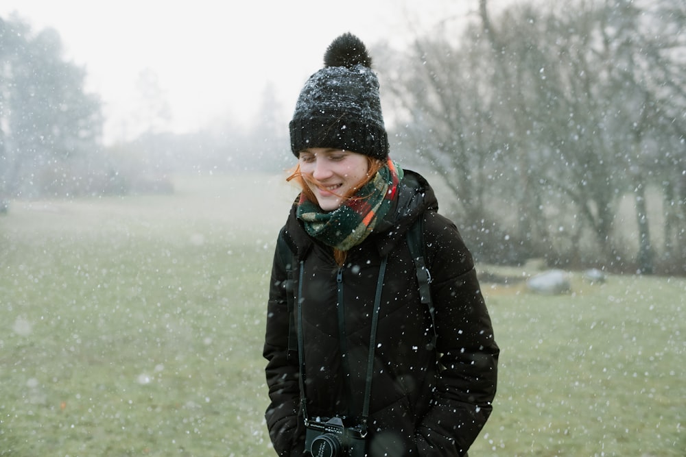 a woman standing in a field in the snow