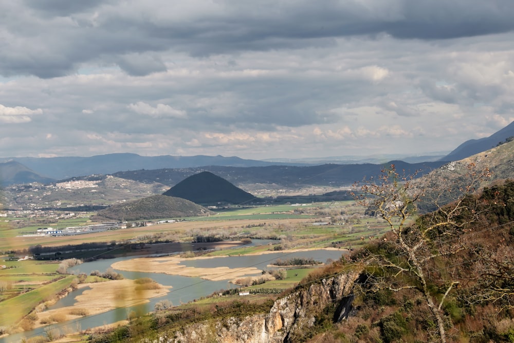 a view of a valley with a river running through it