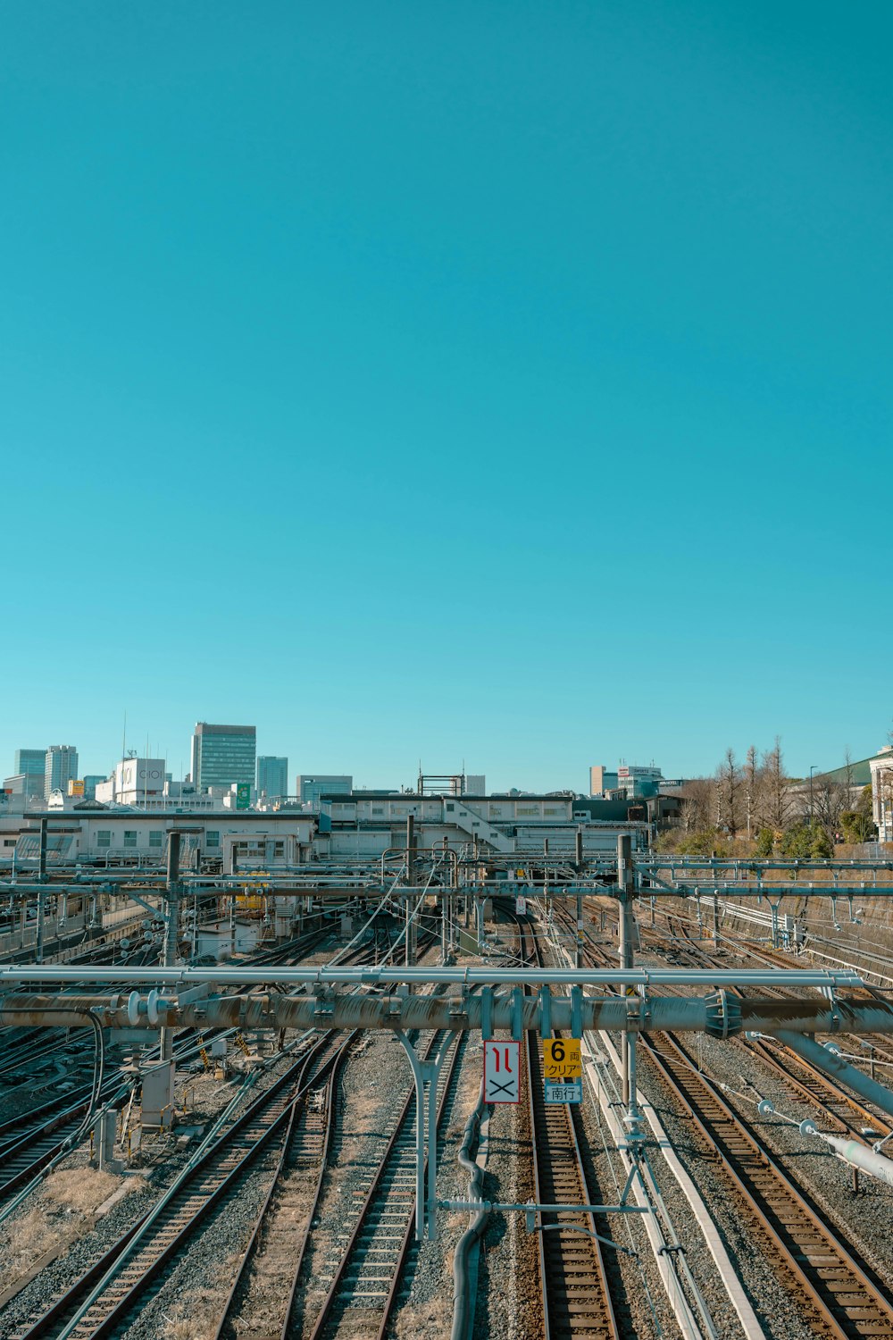 a view of a train track with buildings in the background