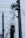 Electrical utility poles with wires and gears are visible. The setup includes weights that may be part of an industrial mechanism or telecommunication infrastructure.