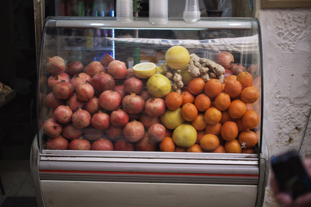 a display case filled with lots of fruit