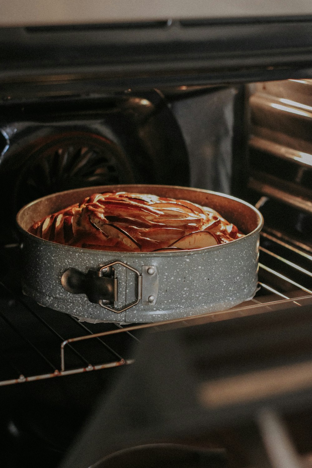 a pot of food cooking in an oven