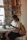 Young woman reading a book in a cozy, well-lit room at Yatrinest