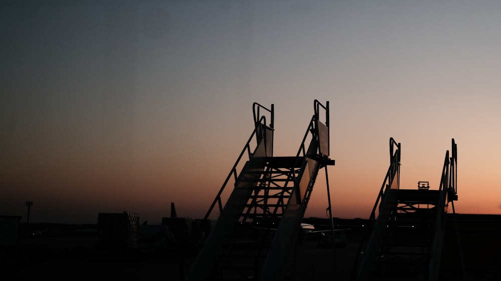 the silhouette of a building against a sunset