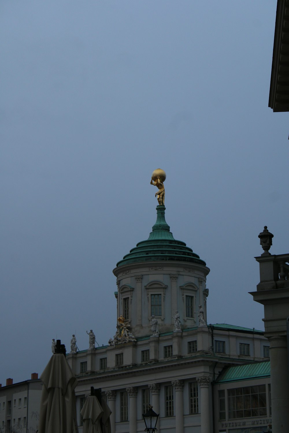 a large building with a gold statue on top of it