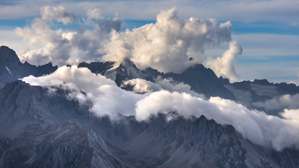 a view of a mountain range covered in clouds