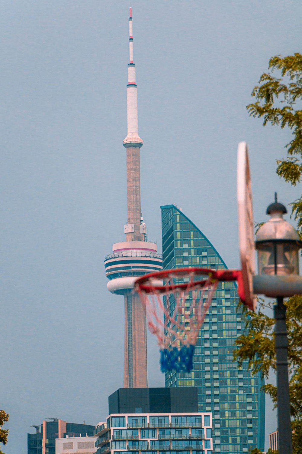 a basketball hoop in front of a tall building