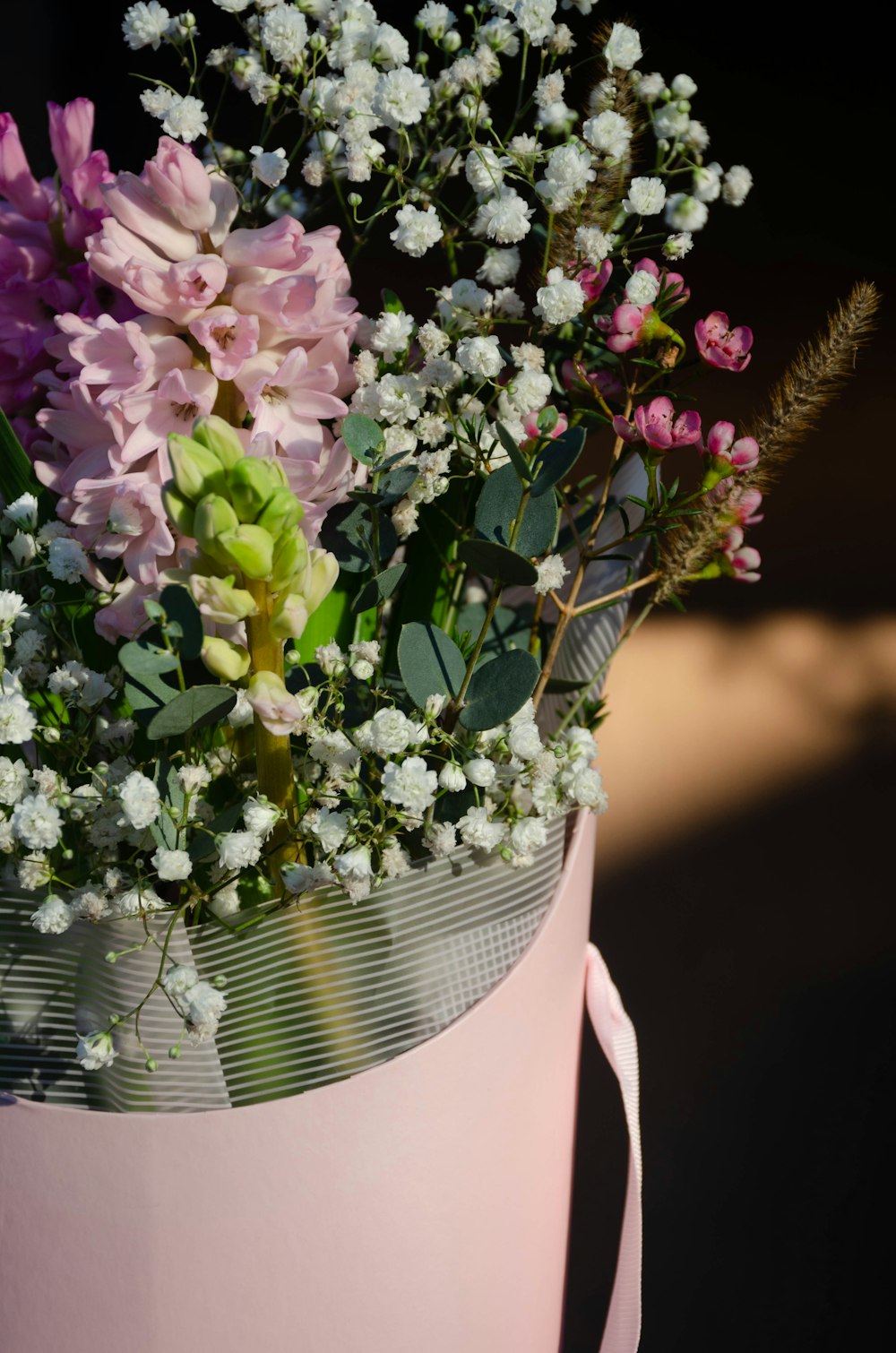 a bouquet of flowers in a pink vase