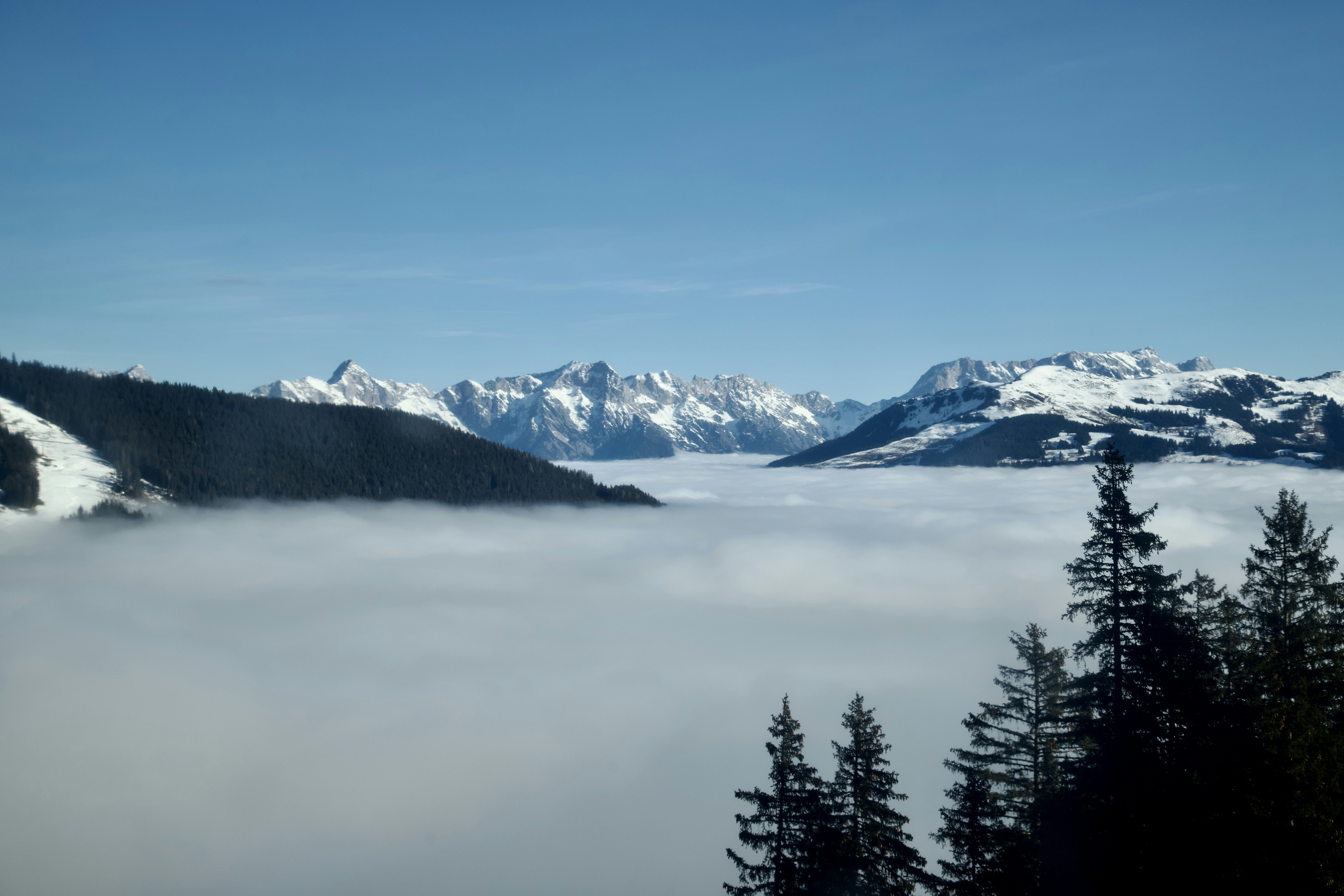 a view of a mountain range covered in clouds