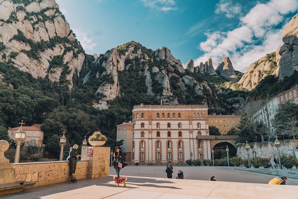 a large building with a mountain in the background