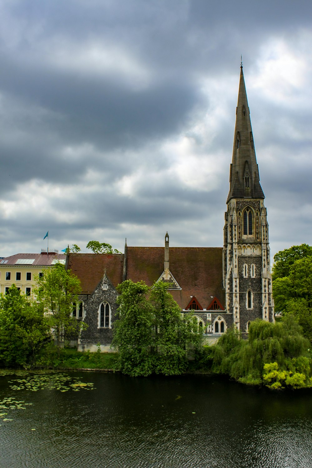 a large building with a tower next to a body of water