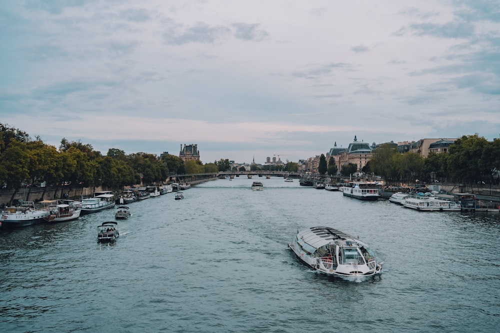 a boat traveling down a river next to a city