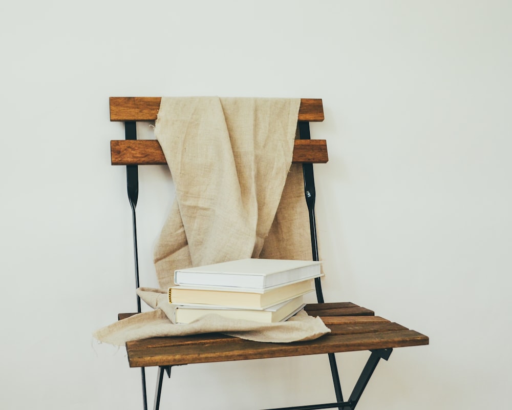 a stack of books sitting on top of a wooden table