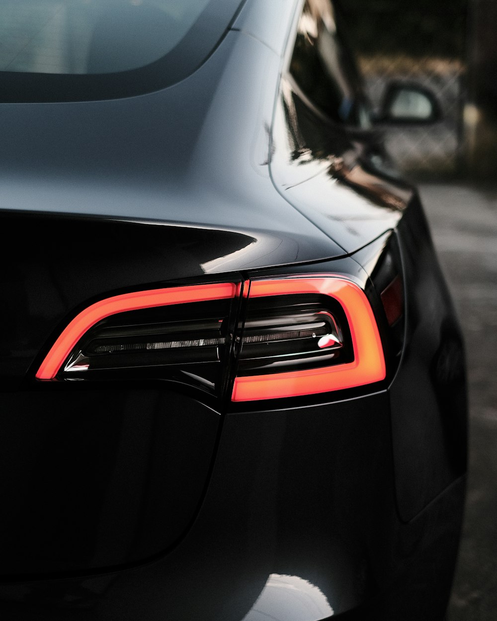 a close up of the tail lights of a black car