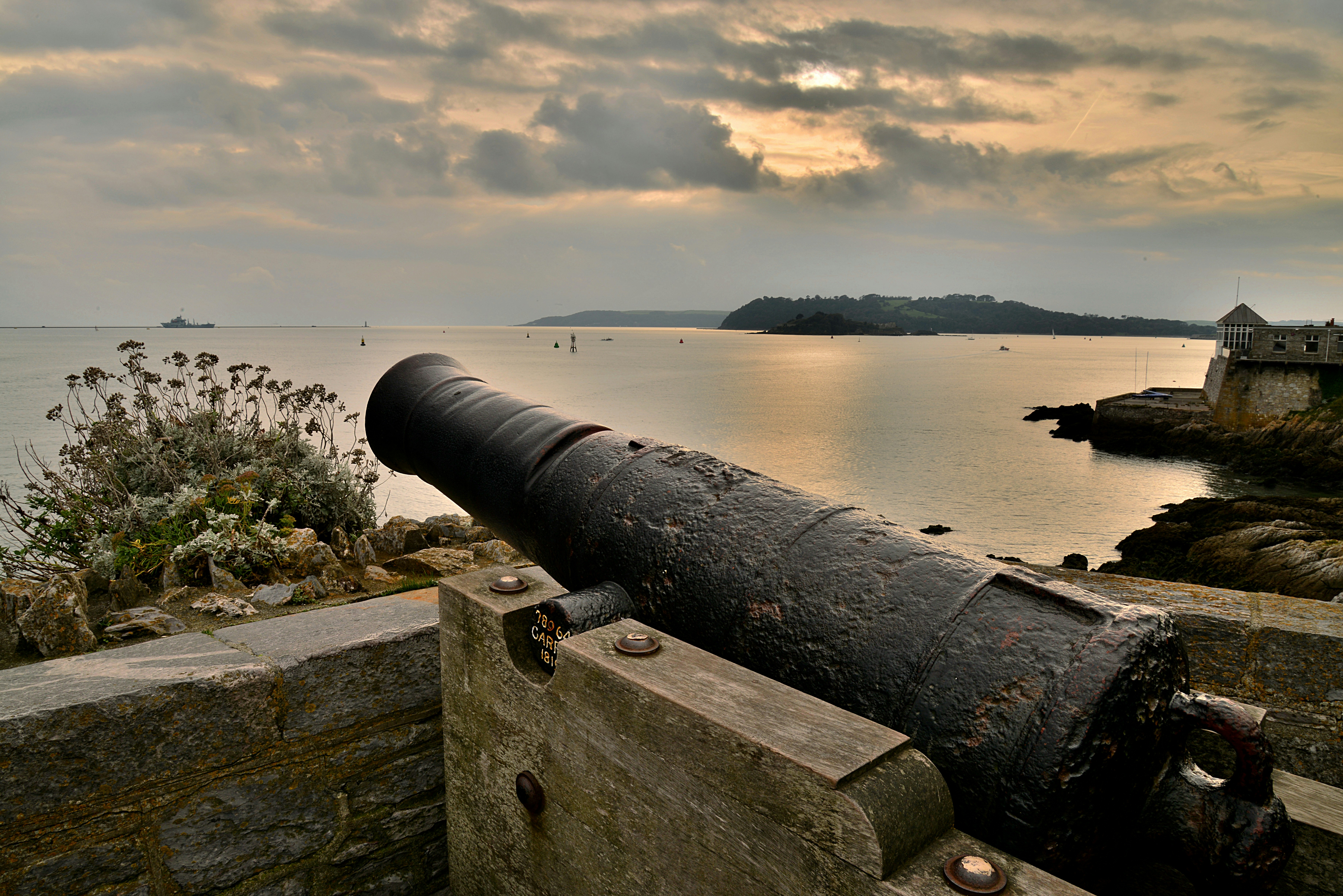 a large cannon sitting on top of a stone wall, 
