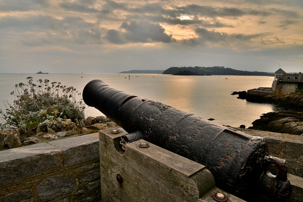 a large cannon sitting on top of a stone wall