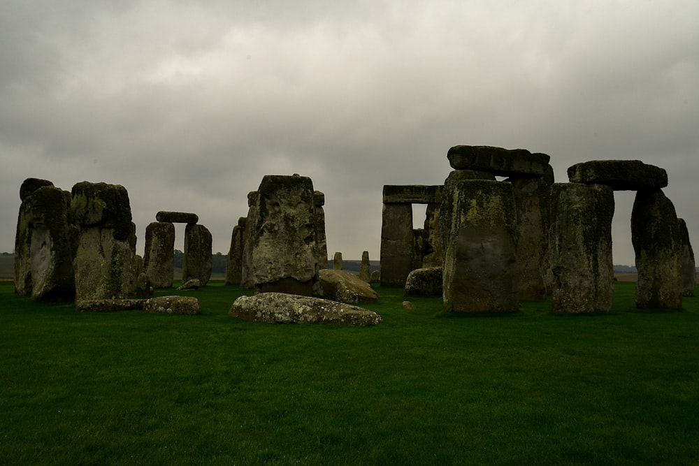 a group of stonehenges in a grassy field