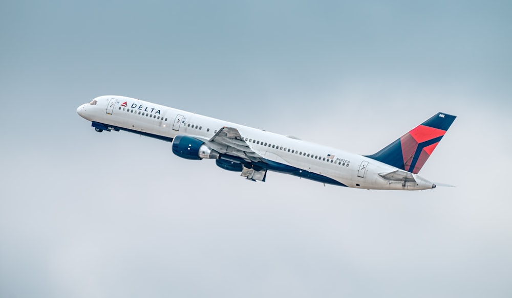 a large passenger jet flying through a cloudy sky