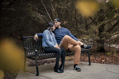 a man and a woman sitting on a bench