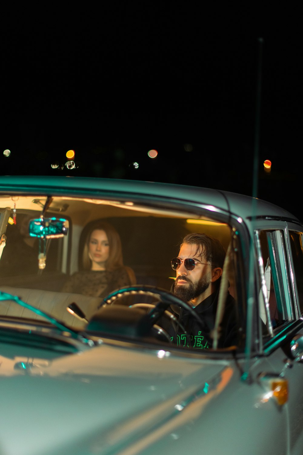 a man and a woman sitting in a car